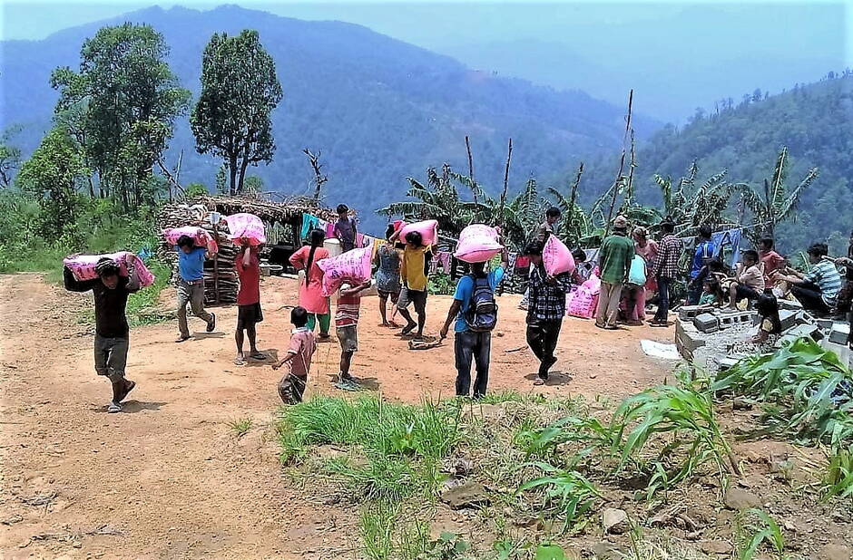 Transport of the heavy sacks of rice to the higher lying villages