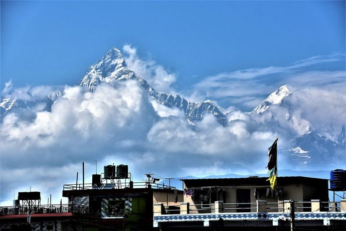 the_mighty_machapuchare_rises_behind_the_green_pasture_hospital_pokhara.jpg