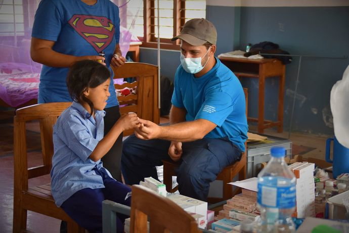 tobias bacchetto distributing medication at navodaya school
